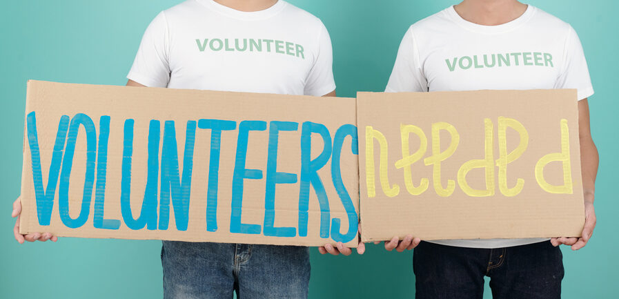 Men Inviting New Volunteers Smiling young men inviting new volunteers in their charitable foundation, isolated on turquoise